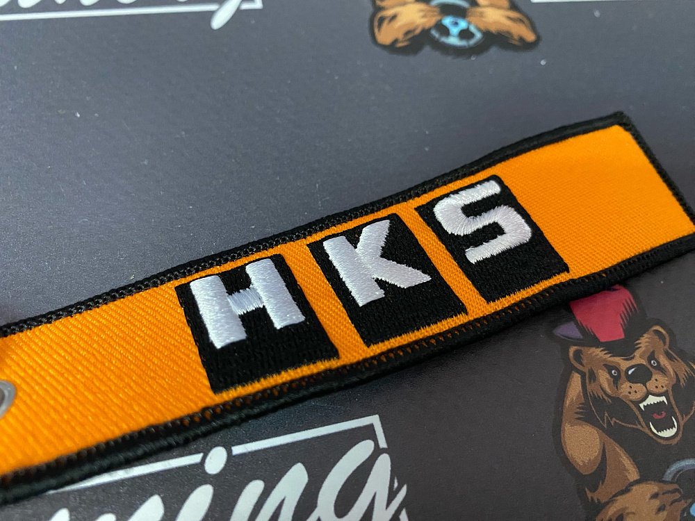 картинка Брелок для ключей HKS "тканевый", оранжевый от магазина  StreetTuning